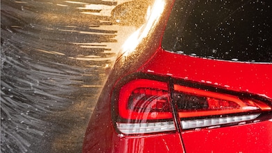 Gros plan sur une voiture rouge dans une station de lavage Shell Car Wash