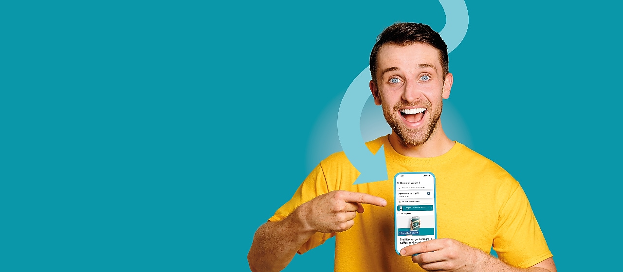 Homme souriant en t-shirt jaune montrant un smartphone dans sa main.