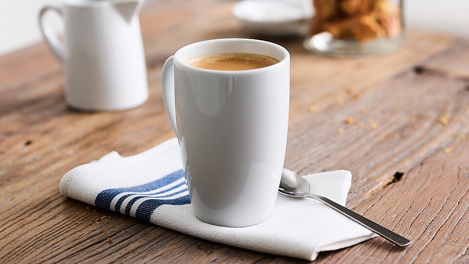 white coffee cup on wooden table